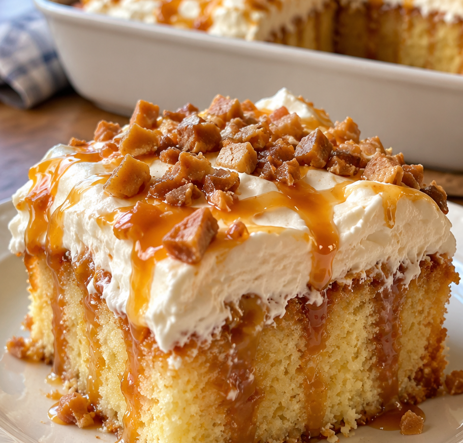 Square slice of caramel poke cake with whipped topping, caramel drizzle, and toffee bits on top